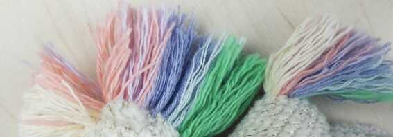 Close-up of the rainbow mane and tail assembly for the amigurumi unicorn, a colorful step in this Quick to Make Amigurumi pattern.