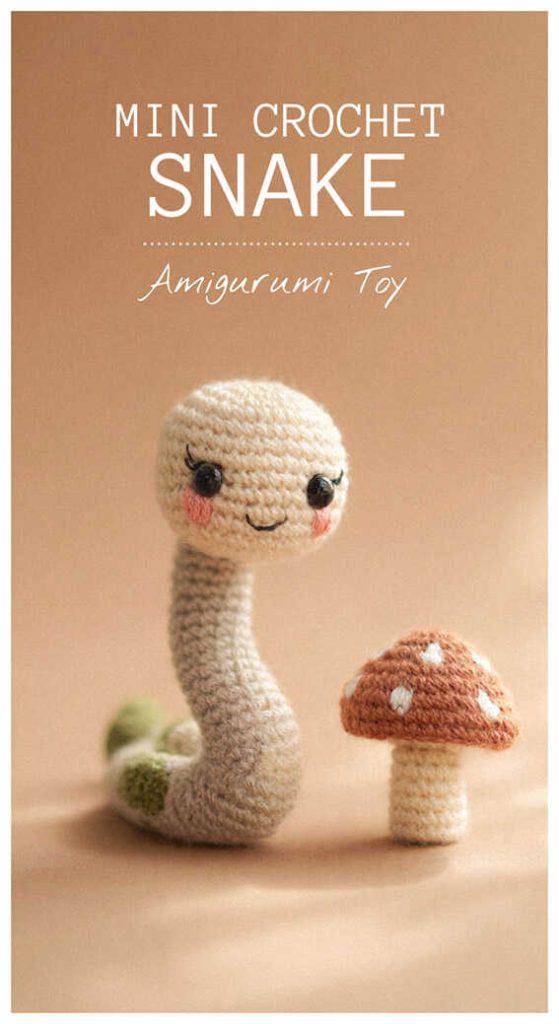 Mini crochet snake amigurumi toy with blush cheeks and small mushroom, handmade snake plush gift idea
